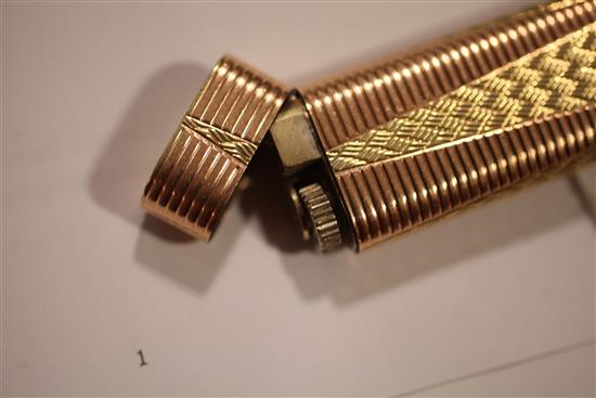 A Cartier two colour gold plated lighter, 2.75in.